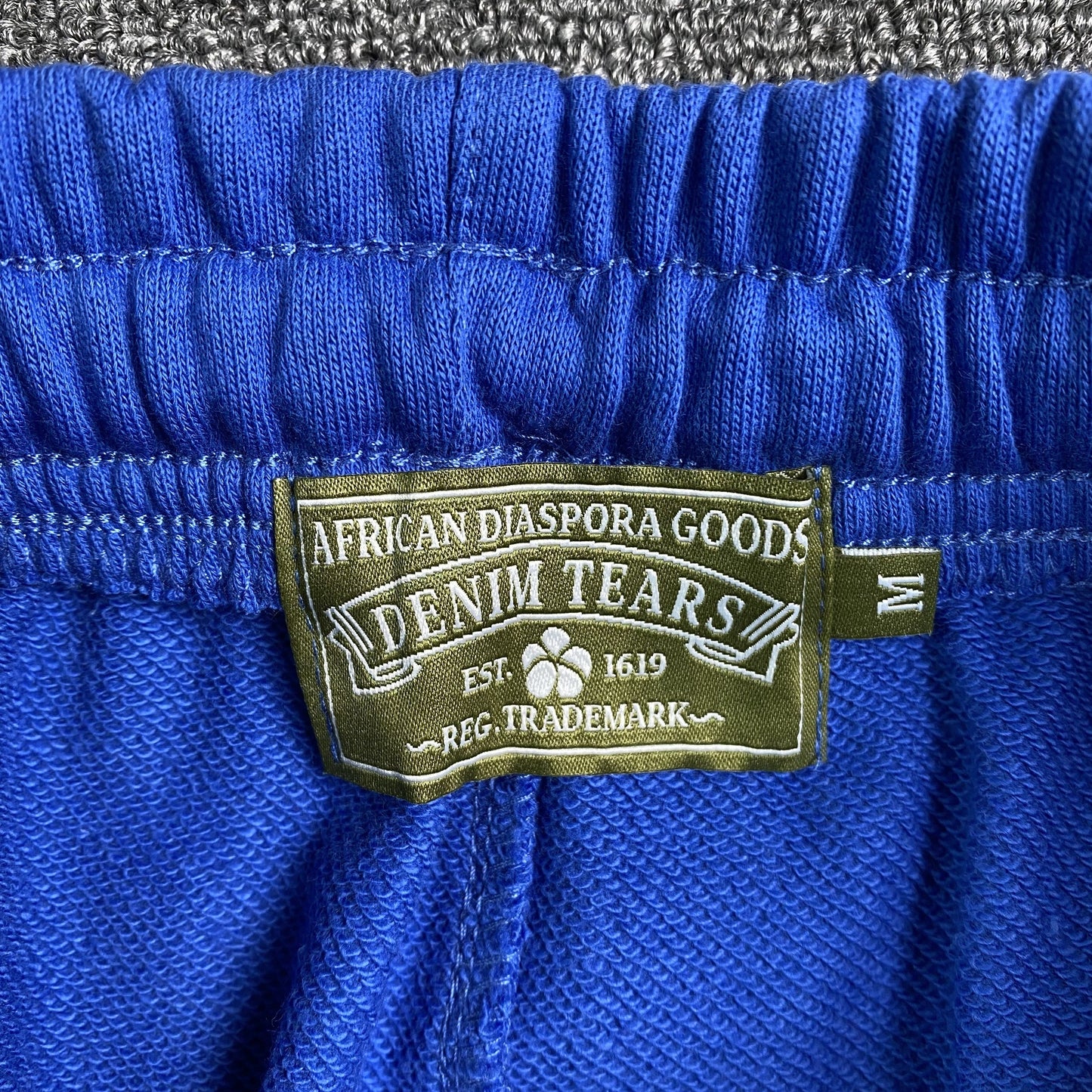 DENIM TEARS THE COTTON WREATH SWEATPANTS ROYAL BLUE