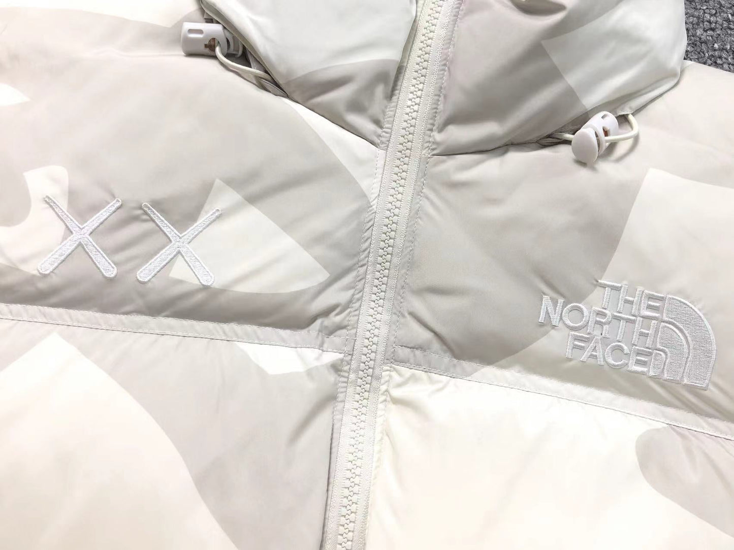 KAWS X THE NORTH FACE RETRO 1996 NUPTSE JACKET MOONLIGHT IVORY